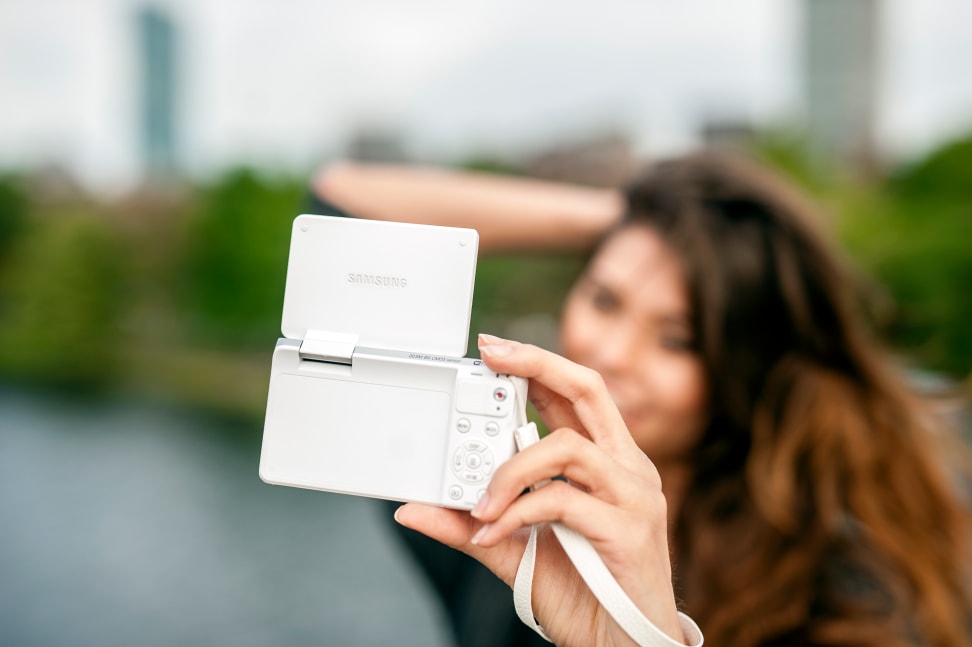 Girl taking selfie with the Samsung NX Mini.