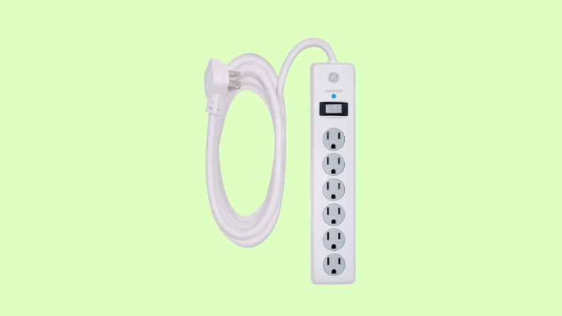 White power strip with curled chord against green background