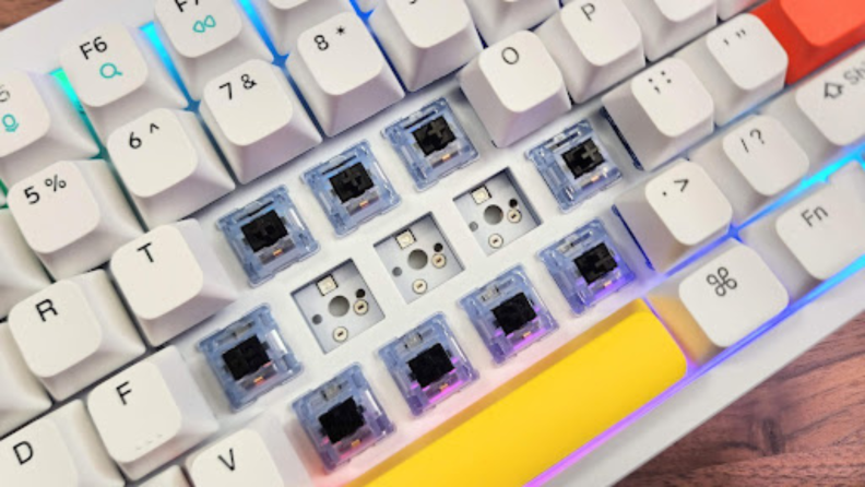 Close-up shot of switches on a Nuphy Halo96 mechanical keyboard that have been pulled out for a hotswap.