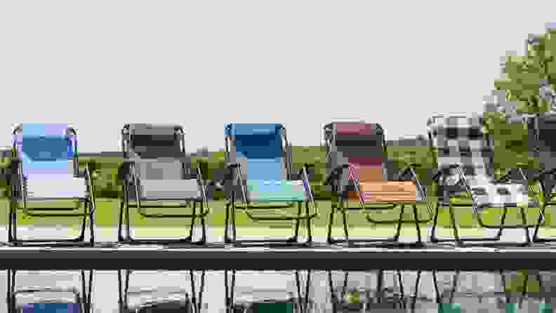 A row of colorful antigravity chairs sitting by a pool.