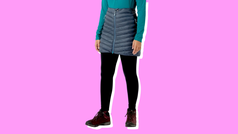 A model wearing a navy blue puffer skirt that zips up the middle.