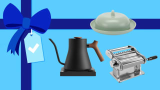 A teapot, butter dish, and pasta maker on a blue gift background
