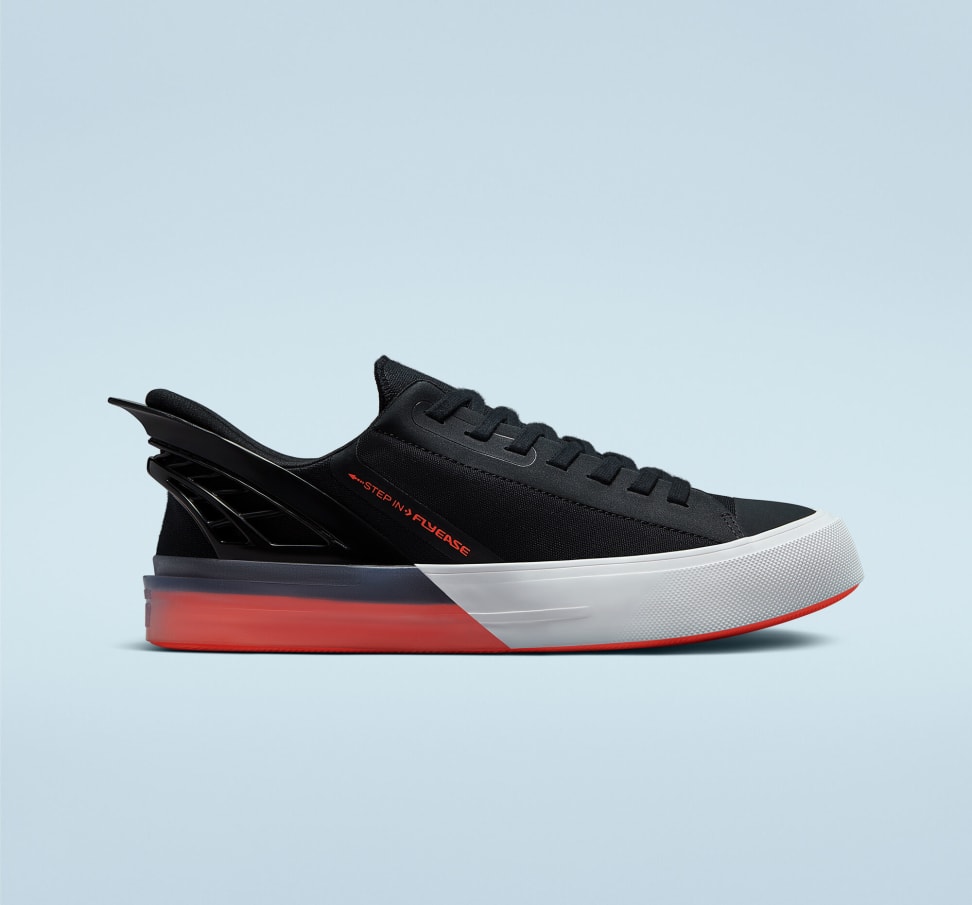 A pair of black, red, and white sneakers on a background