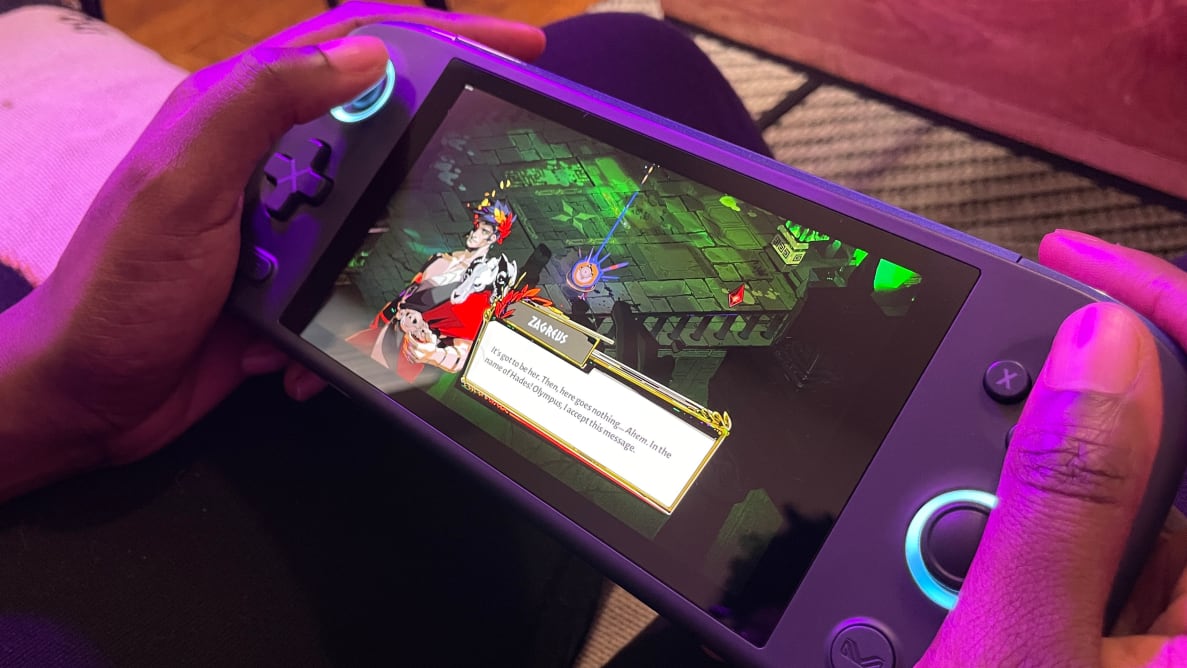 Looking down at a purple handheld, the ayaneo air pro, with the game hades onscreen