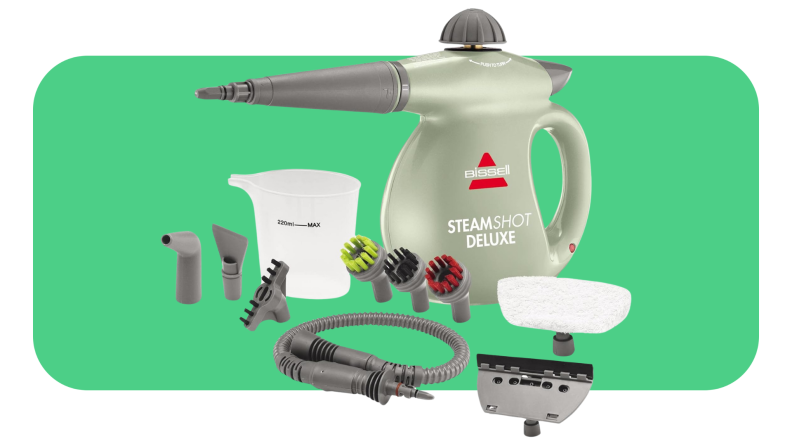 A green steam cleaner surrounded by its attachments.