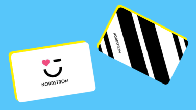 Two Nordstrom gift cards on a blue background.