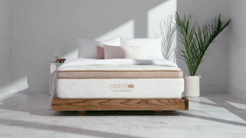 A Saatva mattress inside a minimalistic bedroom.