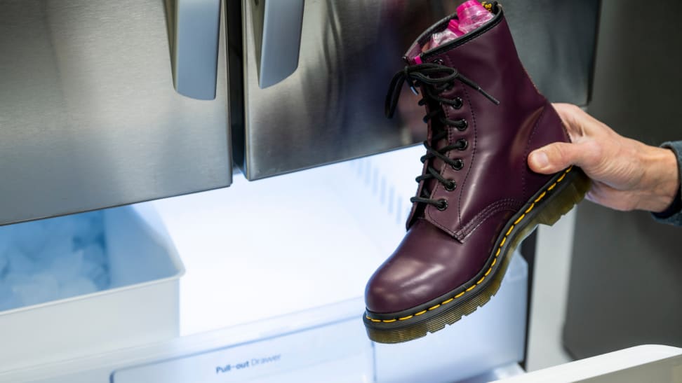 A pair of Doc Martens boots being put into the freezer.