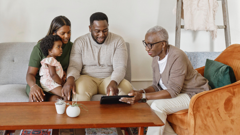 A family sits in a living room together.