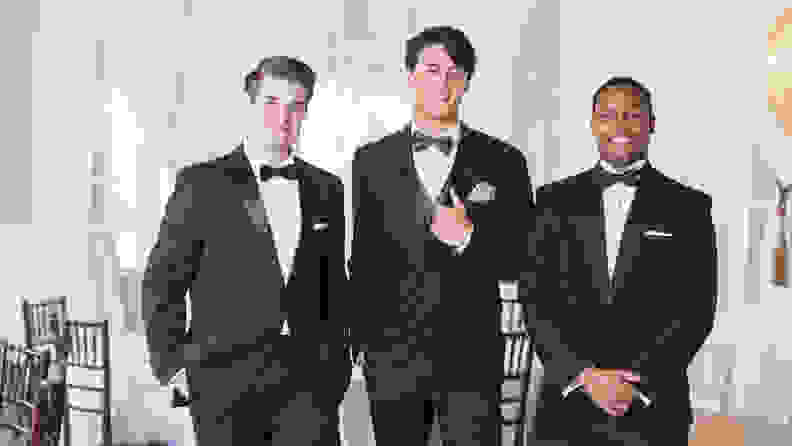 Three men wearing tuxedos at a party.