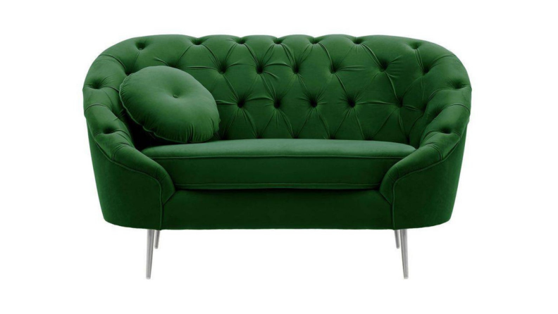 A green velvet quilted seat against a white background.