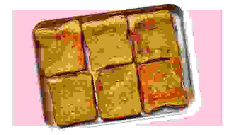 Cooked french toast on cooking tray.
