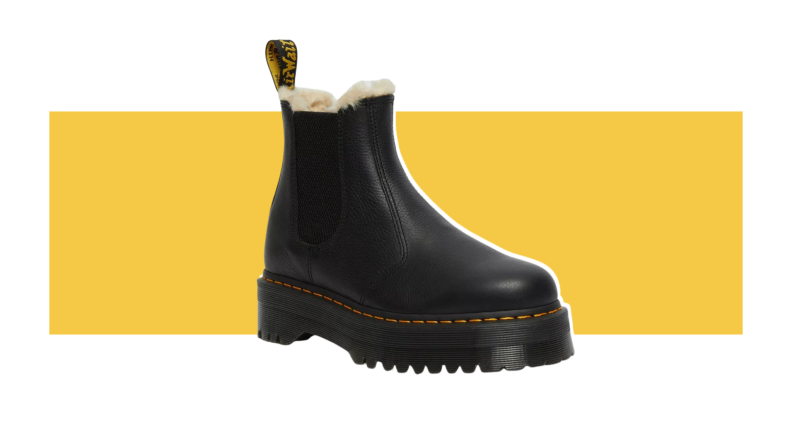A black platform Chelsea boot with white fur lining.