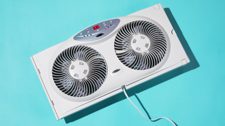 Our pick for best value window fan, the Bionaire BW2300-N, floating on a blue background.