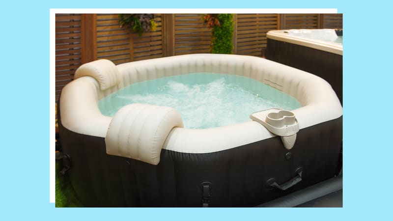 Inflatable hot tub pool with headrests and cup holders.