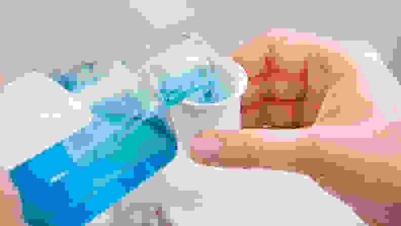 A photo of someone pouring mouthwash.