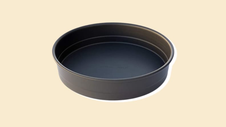 A round pan on a beige background.