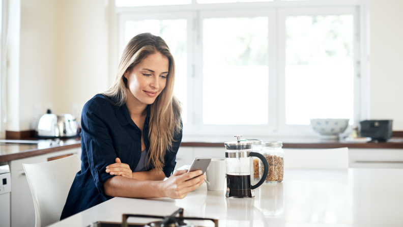 Woman in kitchen on phone