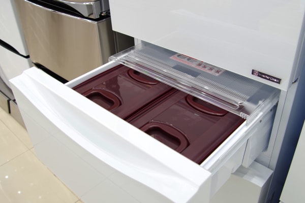 An open pull-out drawer on an LG kimchi refrigerator.