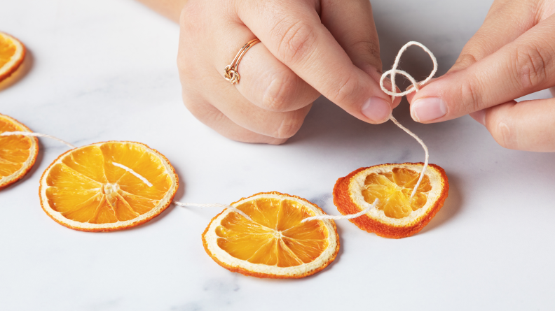 A person looping the end of a piece of twine.