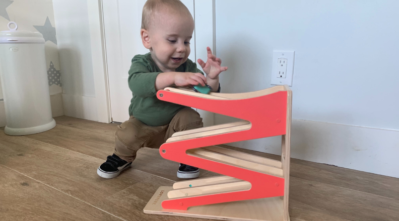 A child plays with a race car ramp