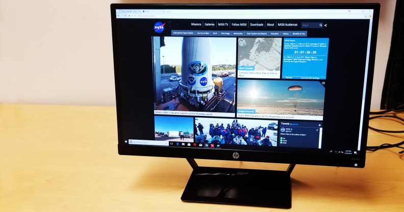 An HP monitor on a desk, turned on