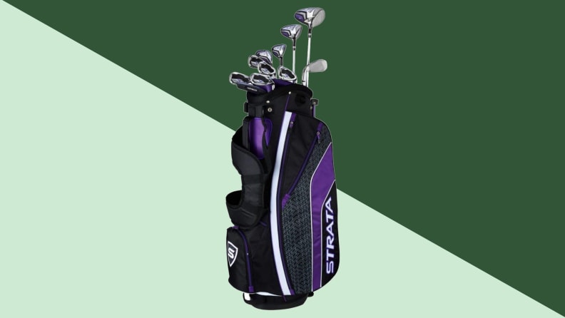 An image of a set of golf clubs in a purple club bag, seen upright with the tops of the golf clubs extending up out of the bag.