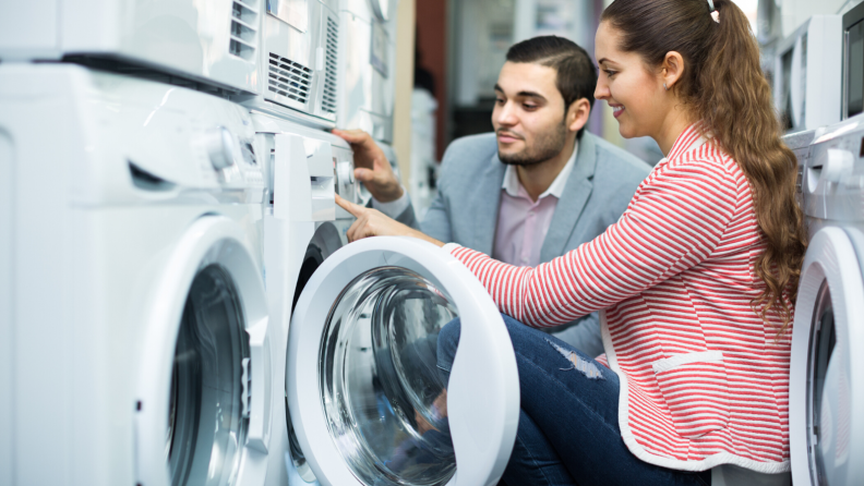 Woman in front of a dryer with a man behind her