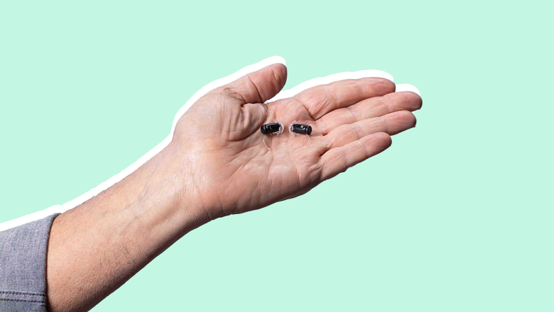 Person holding the Eargo 6 Hearing Aids in the palm of their hand.