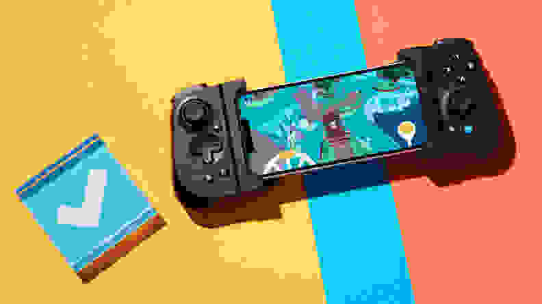 A mobile gaming handheld wrapped around a phone with a colored background and a blue checkmark on the left side