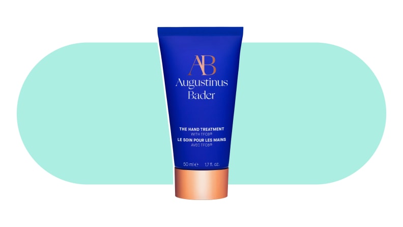A tube of Augustinus Bader Hand Treatment on a colorful background