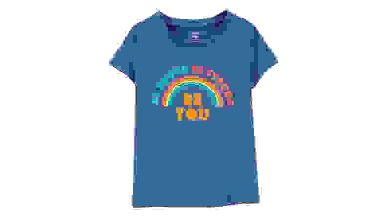 Blue tshirt on a white background with a rainbow across it that says "Be Proud Be Strong Be You"