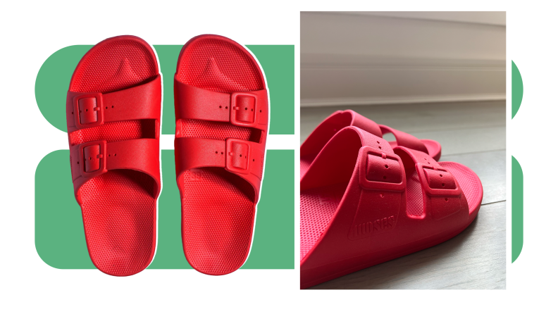 Close up of the decorative buckle and strap of the red Freedom Moses sandal.