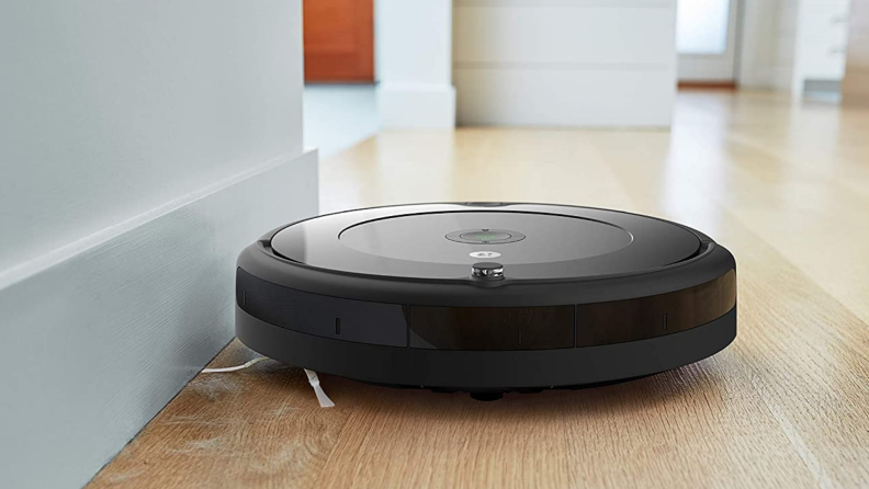 The  iRobot Roomba 692 cleaning a wooden floor.