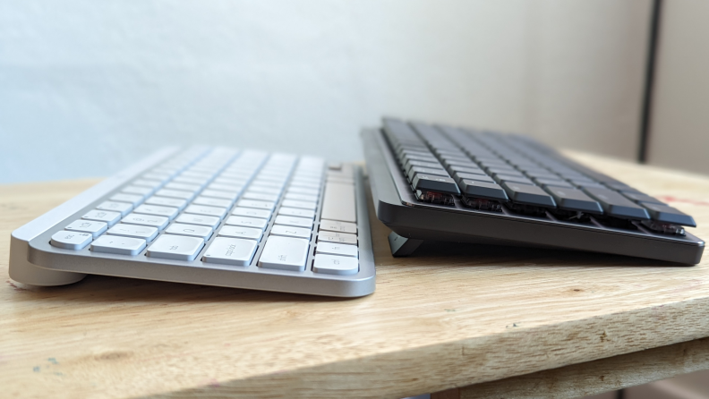 A white and black keyboard on a desktop.