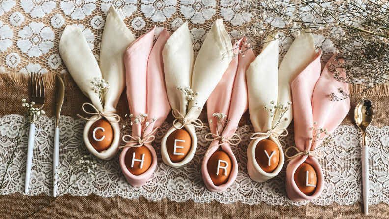 An Easter arrangement with eggs and napkins spelling out the name "Cheryl."
