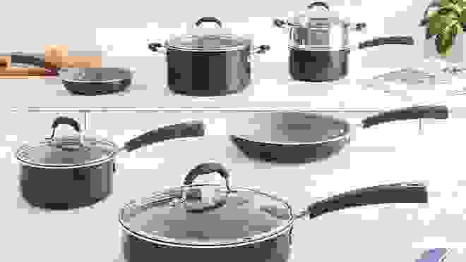 An assortment of Cuisinart pots and pans on a countertop.