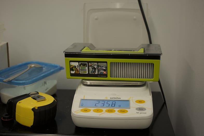 Weighing the canister for a robot vacuum.
