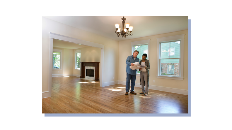 Homeowner standing with contractor to discuss home issues.