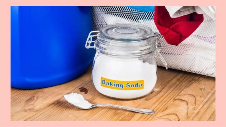 Baking soda in a labeled jar with a spoon on a wooden table