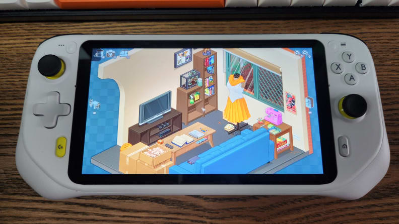 A handheld gaming console showing a game with many objects on screen