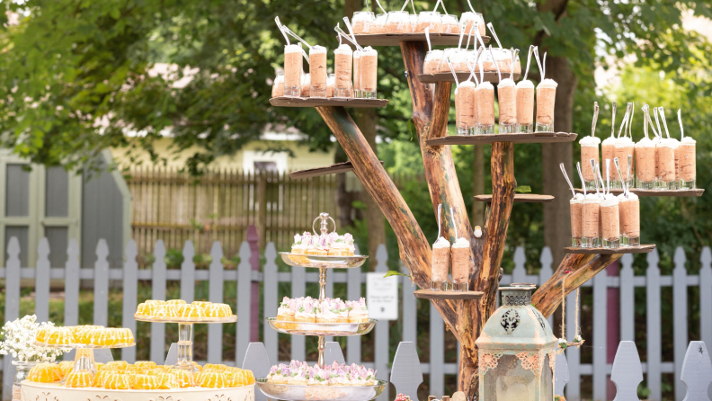 A table of drinks and lemon cake.