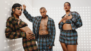 Three models wearing plaid pajamas in front of white walls.