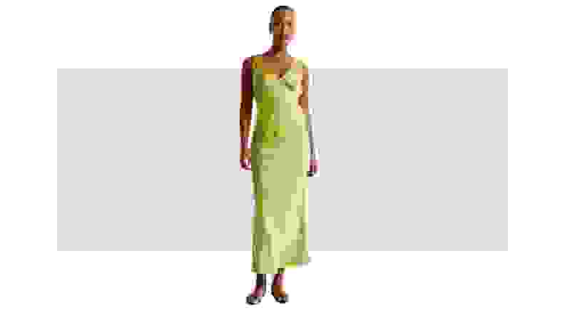 A model wearing a green satin dress.