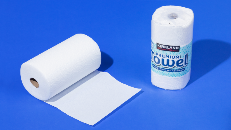 A roll of Kirkland Signature paper towels on a blue background.