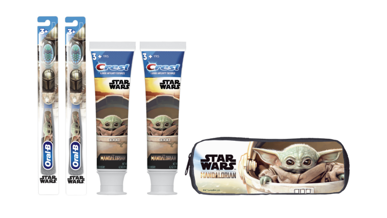 An image of a Star Wars dental care set including two toothbrushes, two tubes of toothpaste, and a carrying case featuring baby Yoda.