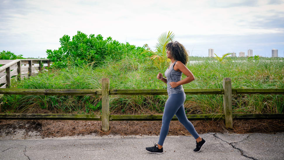 A woman power walking outside.