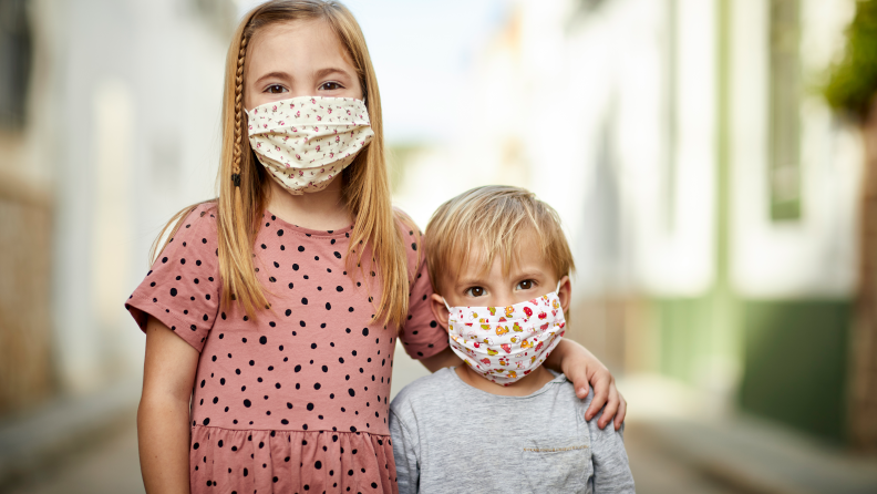 Boy and girl wearing cloth masks.