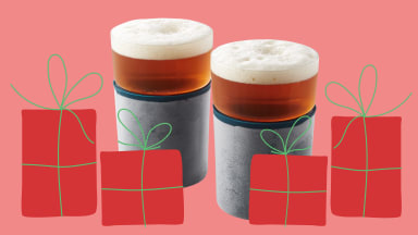 Two glasses of beer behind red Christmas gifts