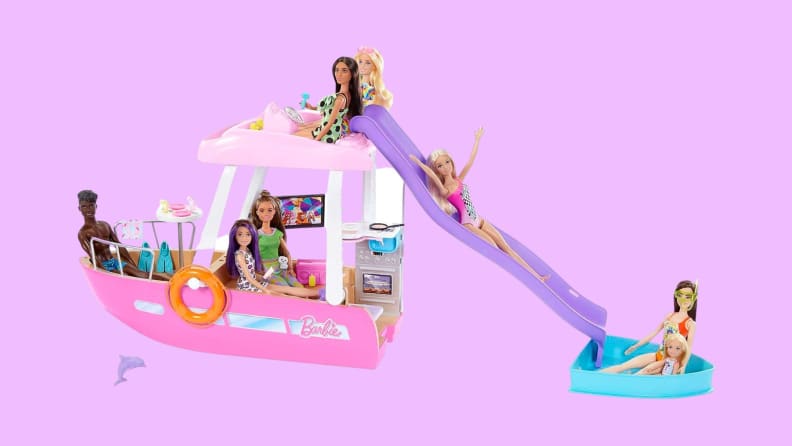 A Barbie Dream Boat with six Barbie dolls in and around it in poses of frolic.